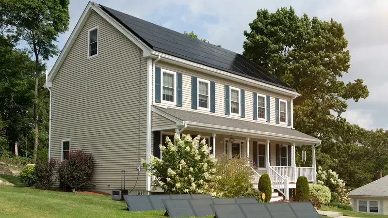 Virginia home with rooftop and ground-mount solar panels, illustrating residential solar system cost in 2026