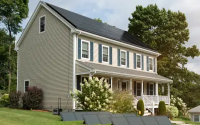 Virginia home with rooftop and ground-mount solar panels, illustrating residential solar system cost in 2026