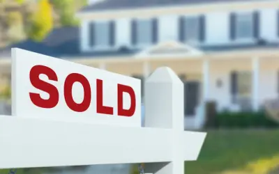 Home for sale sign in front of house