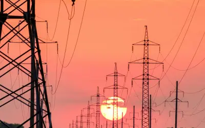 Power lines with sun setting behind them