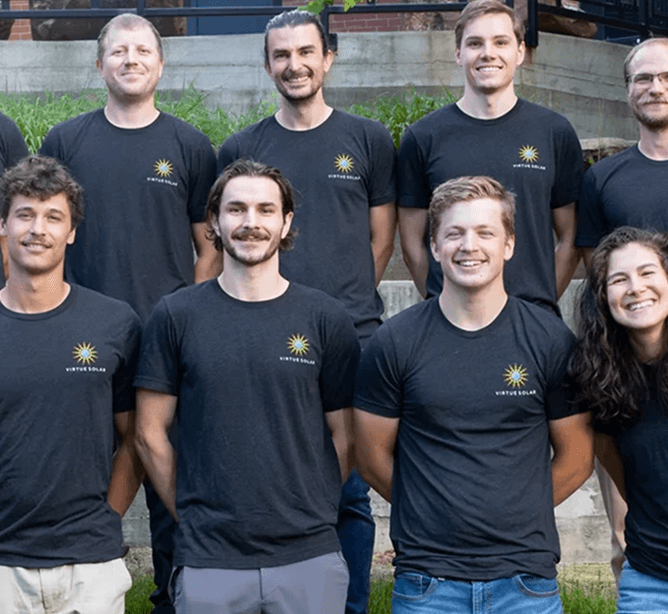 Smiling Virtue Solar employee unloading van