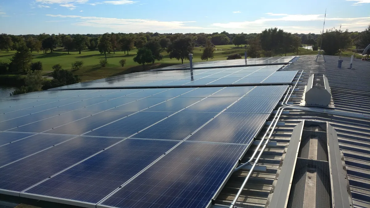 Commercial solar panels installed on a metal warehouse roof