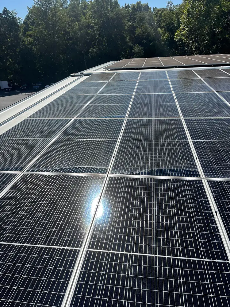 Close-up of a rooftop commercial solar array catching the sun in Virginia