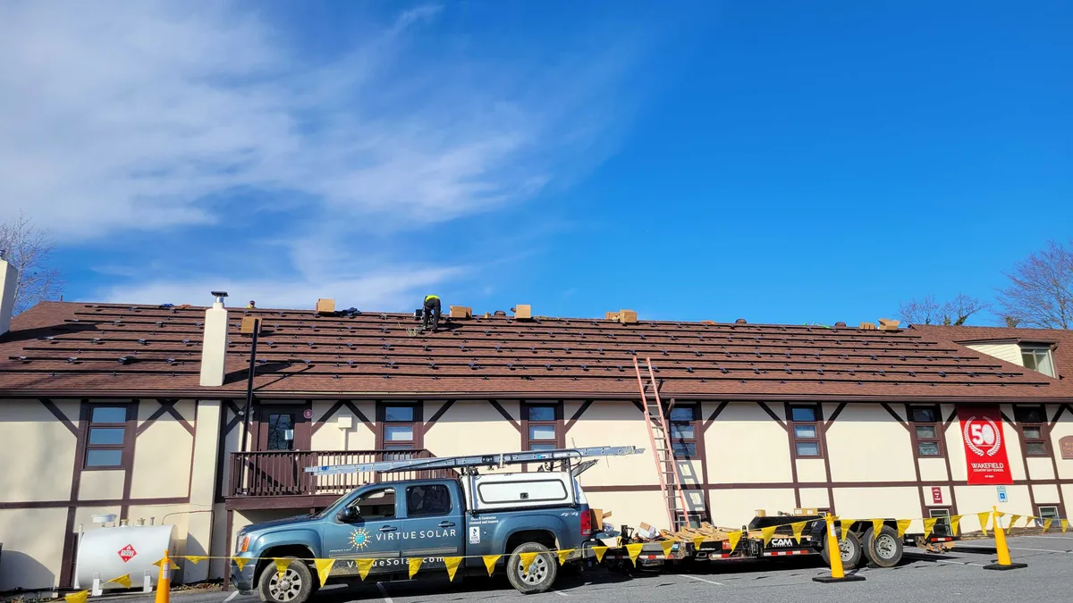 Virtue Solar crew installing a roof-integrated solar system at a Virginia school
