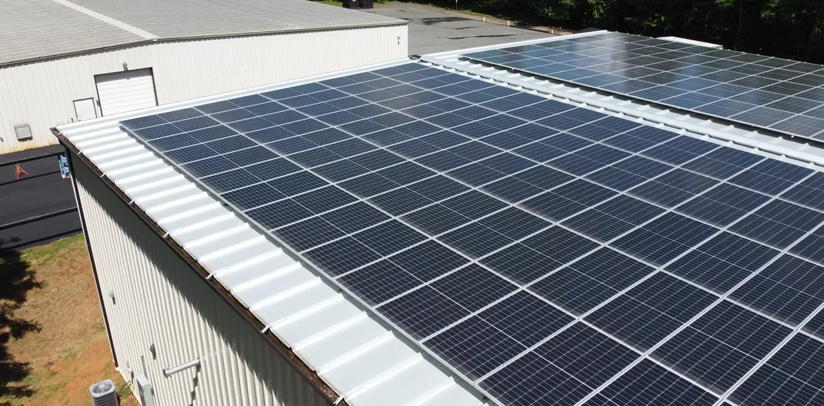 Aerial view of a commercial rooftop solar array on a warehouse in Virginia