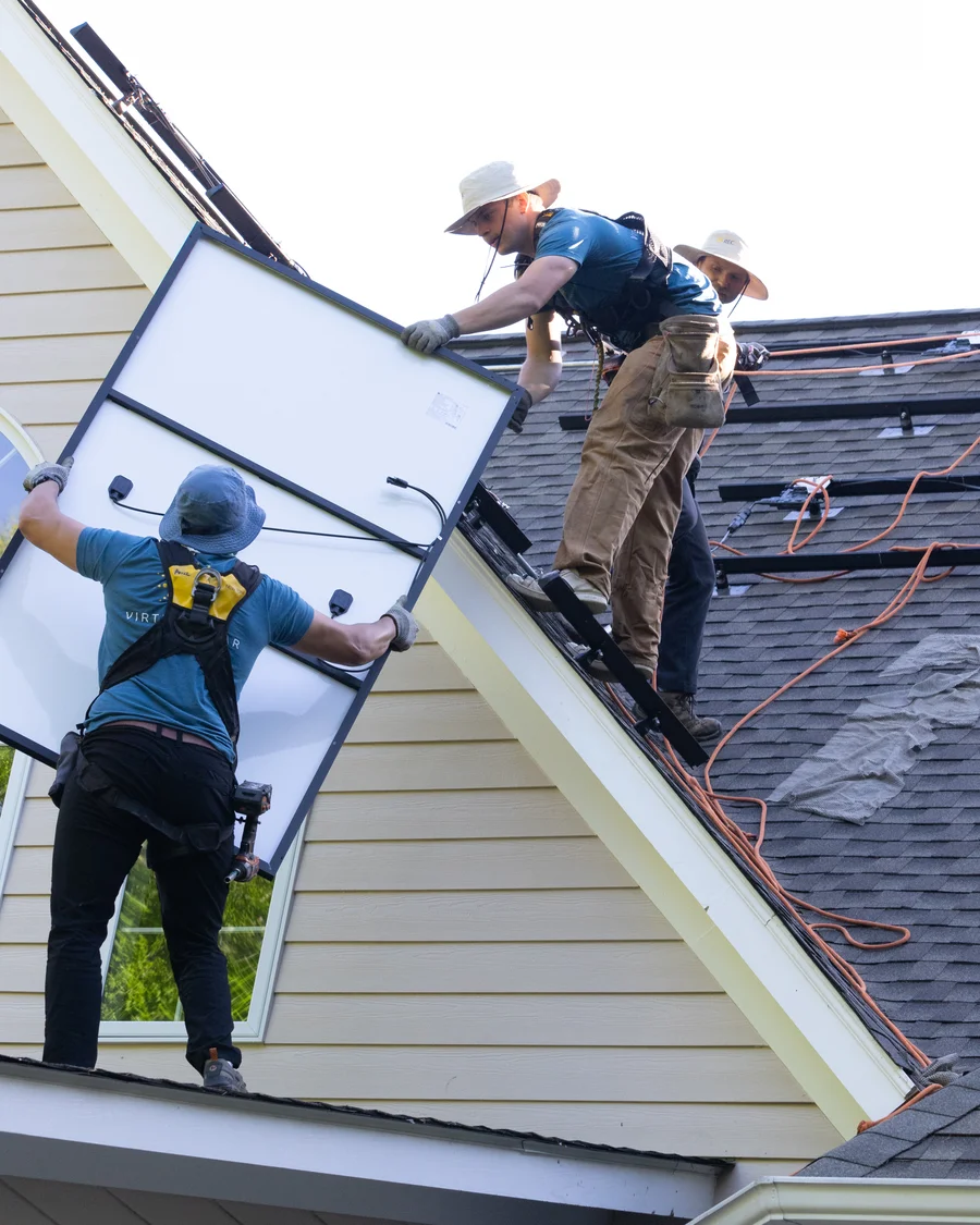 Virtue Solar team installing solar panels on a rooftop in Virginia