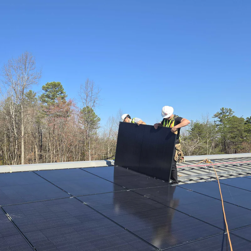 Virtue Solar technicians adding panels to an existing rooftop array in Virginia