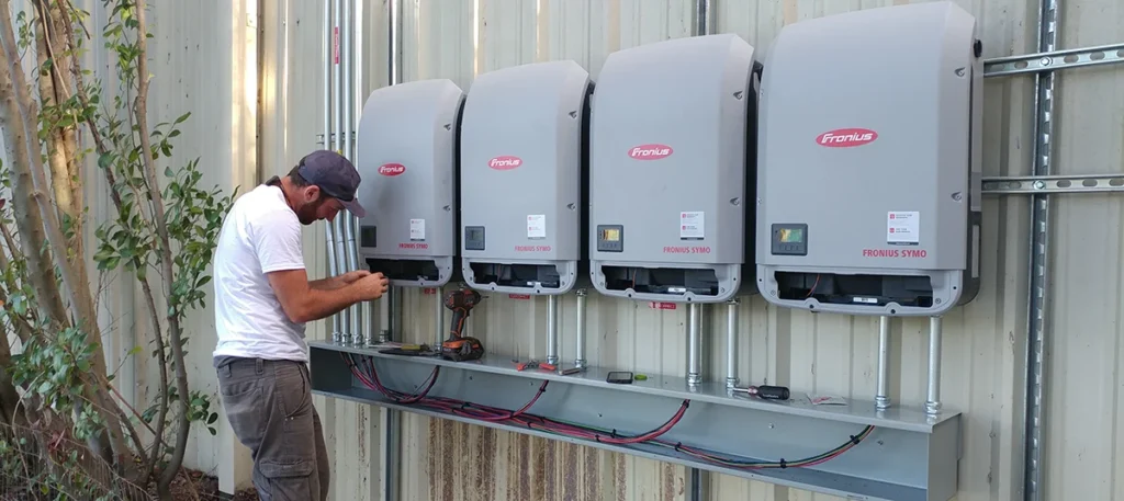 Fronius string inverters being installed by Virtue on a commercial property.