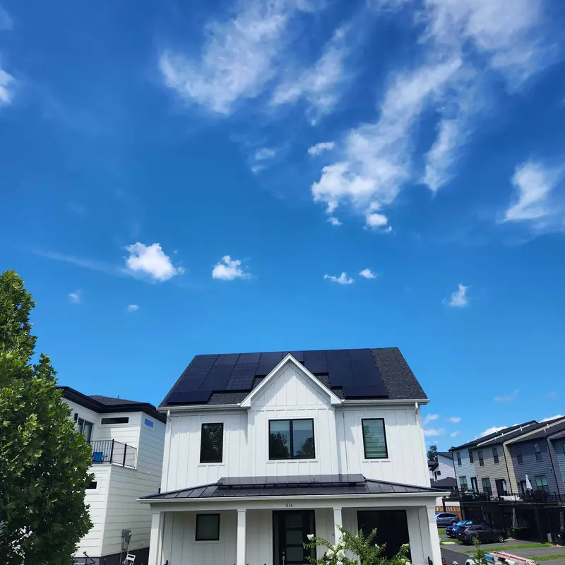 nice black solar panels on white modern home
