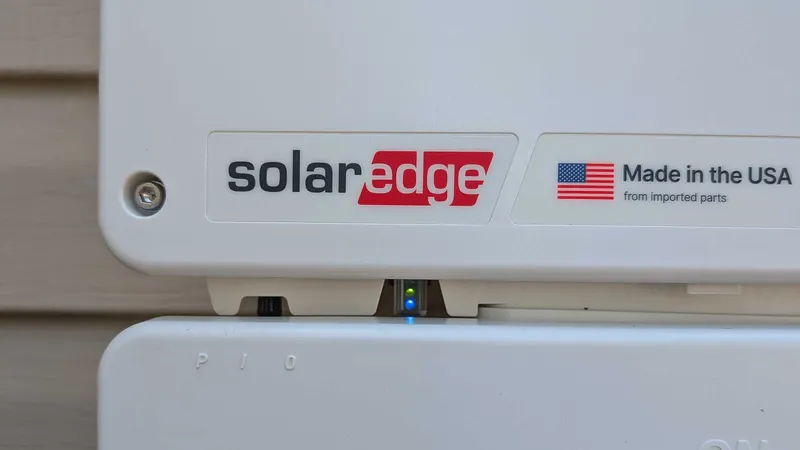 SolarEdge inverter with green production and blue communication lights on
