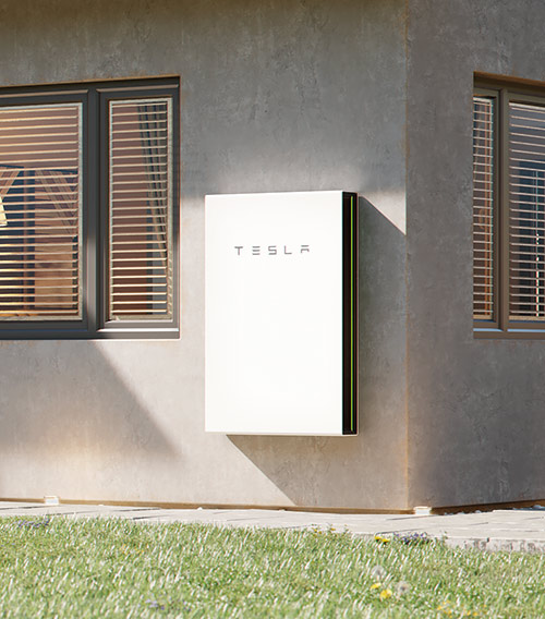 Tesla Powerwall installed on exterior of solar home.